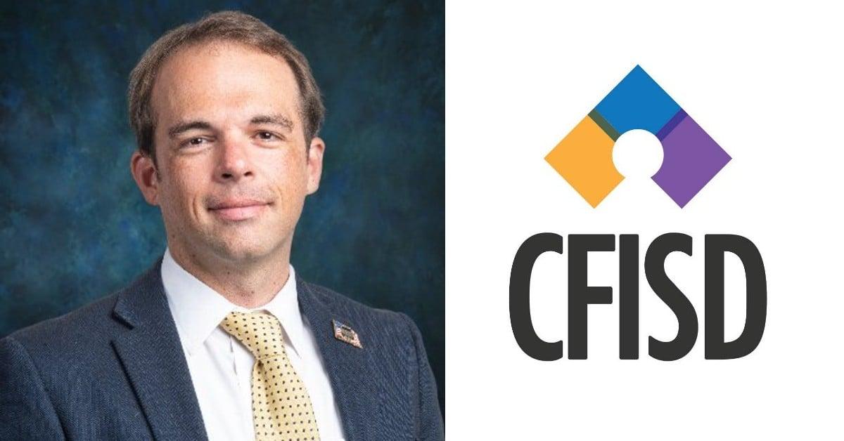 Professional portrait of an administrator in a dark suit and yellow tie, alongside the CFISD district logo