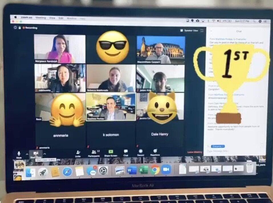 Screenshot of a Zoom video conference with multiple participants, emoji reactions, and a first place trophy graphic