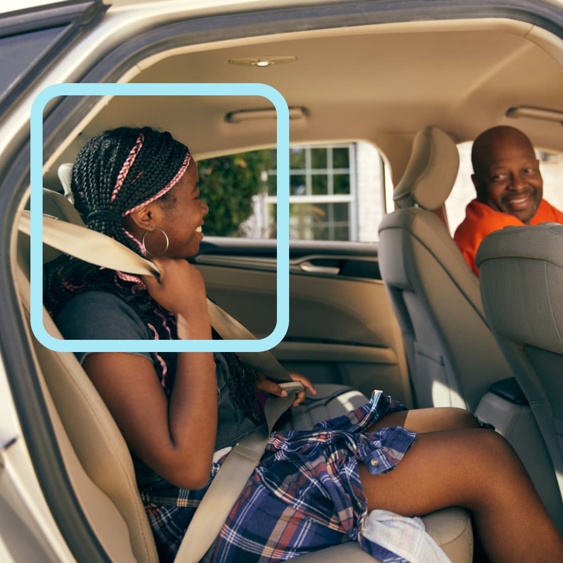 Passengers engaged in friendly conversation inside a car with beige interior, showing a warm social interaction during the ride