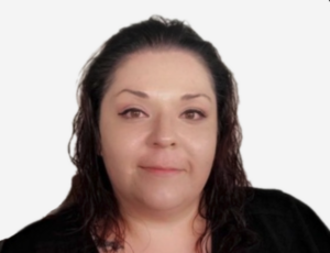 Professional headshot of a woman with dark hair and a warm smile wearing black against a white background