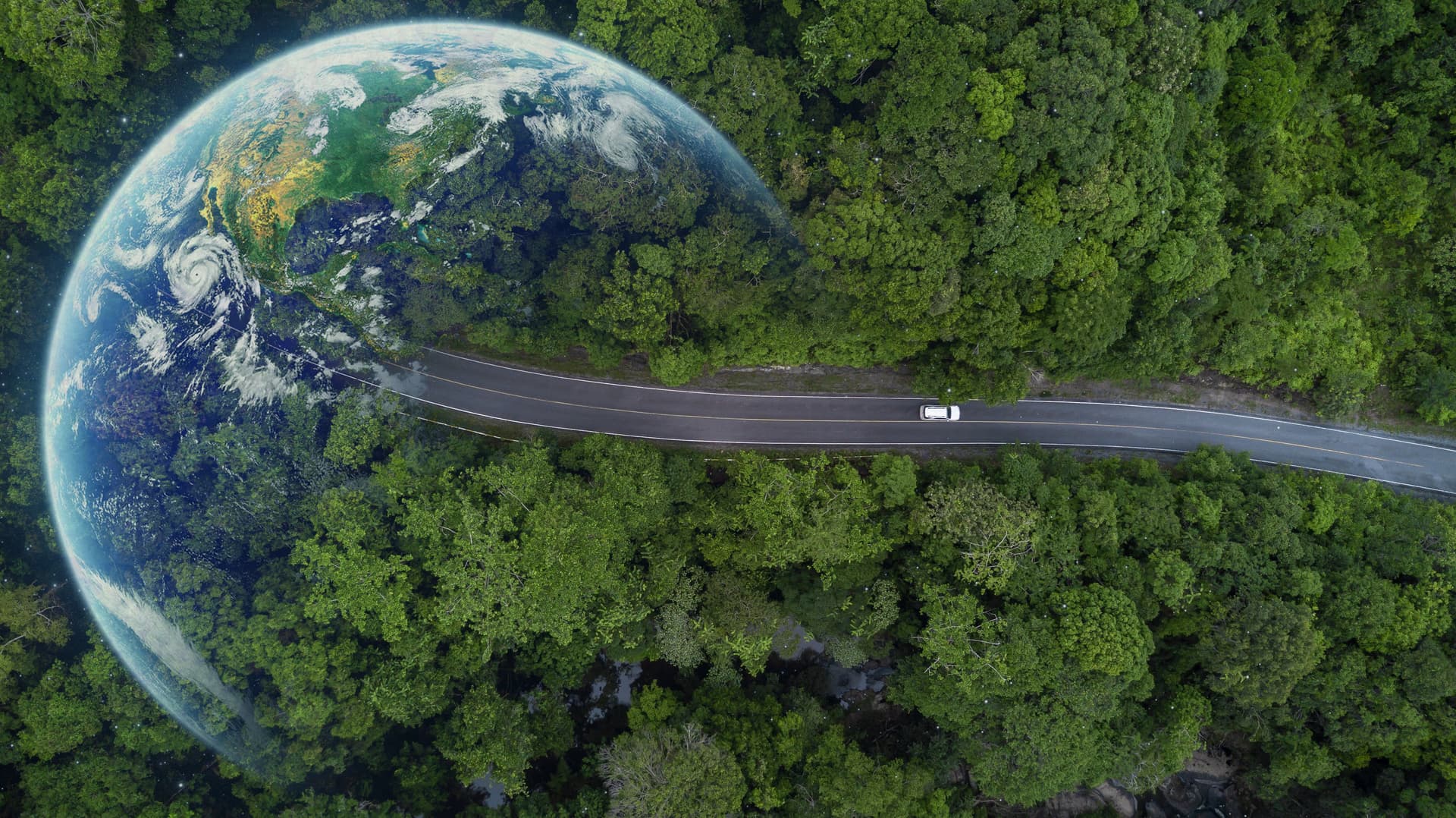 Aerial view of a curved road through forest merging with Earth view from space in a surreal composite image